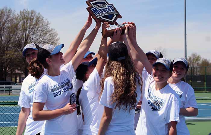 Members of the Charger women's tennis team hold up their G-MAC Tournament championship trophy. Photo by Liz Wacienga/Kentucky Wesleyan College